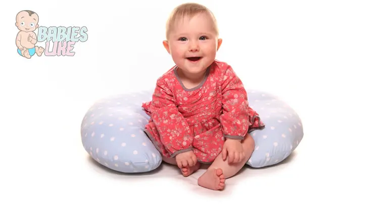 Baby using a boppy pillow for support.